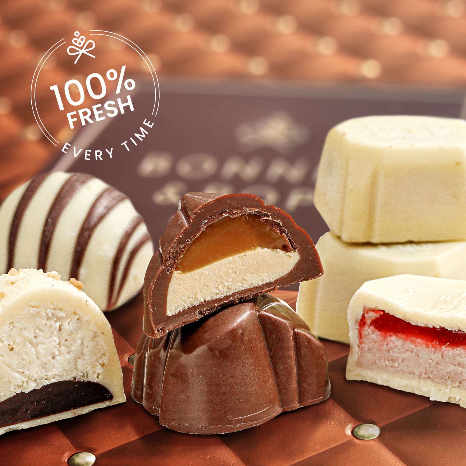 An elegant copper and gold quilted gift tin from Bonnie & Pop with an assortment of handcrafted Belgian chocolate truffles displayed inside.