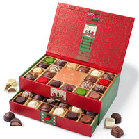 This Christmas Chocolate Truffle Gift Box open to reveal a variety of gourmet chocolate truffles inside. The box is red with green accents and has a decorative design.