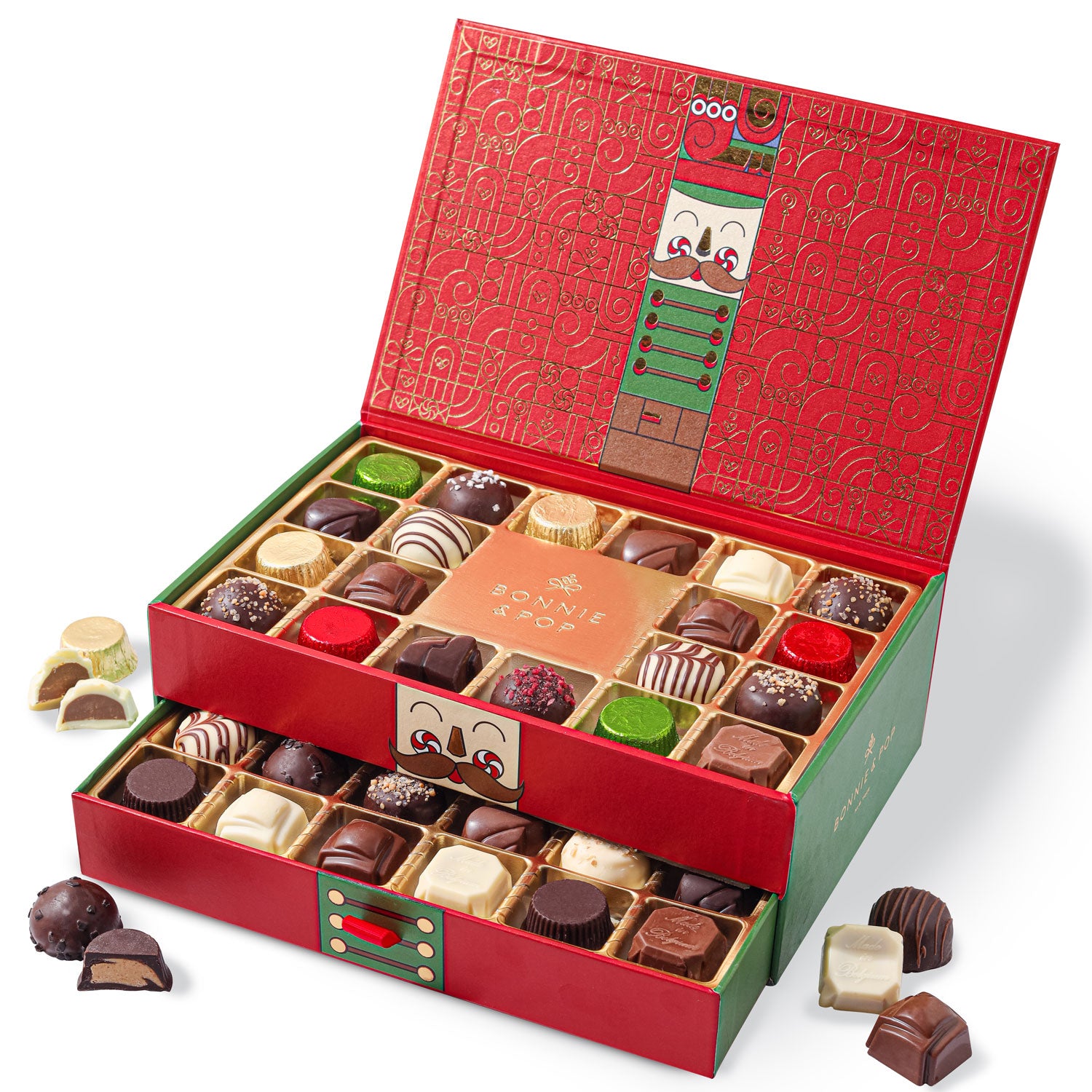 This Christmas Chocolate Truffle Gift Box open to reveal a variety of gourmet chocolate truffles inside. The box is red with green accents and has a decorative design.