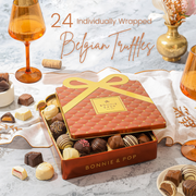 An elegant copper and gold quilted gift tin from Bonnie & Pop with an assortment of handcrafted Belgian chocolate truffles displayed inside.