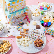 Make every birthday unforgettable. This three-tier birthday gift tower is packed with chocolates, cookies, nuts, and festive treats—beautifully wrapped and ready to wow.