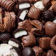 Bring holiday cheer with this Christmas chocolate gift box—a festive keepsake tin brimming with gourmet chocolates, caramels, and other seasonal delights.