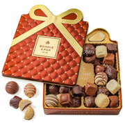 An elegant copper and gold quilted gift tin from Bonnie & Pop with an assortment of handcrafted Belgian chocolate truffles displayed inside.
