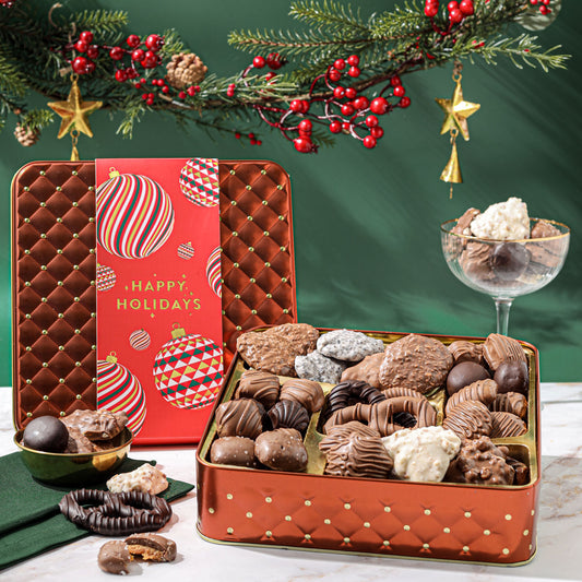 Bring holiday cheer with this Christmas chocolate gift box—a festive keepsake tin brimming with gourmet chocolates, caramels, and other seasonal delights.