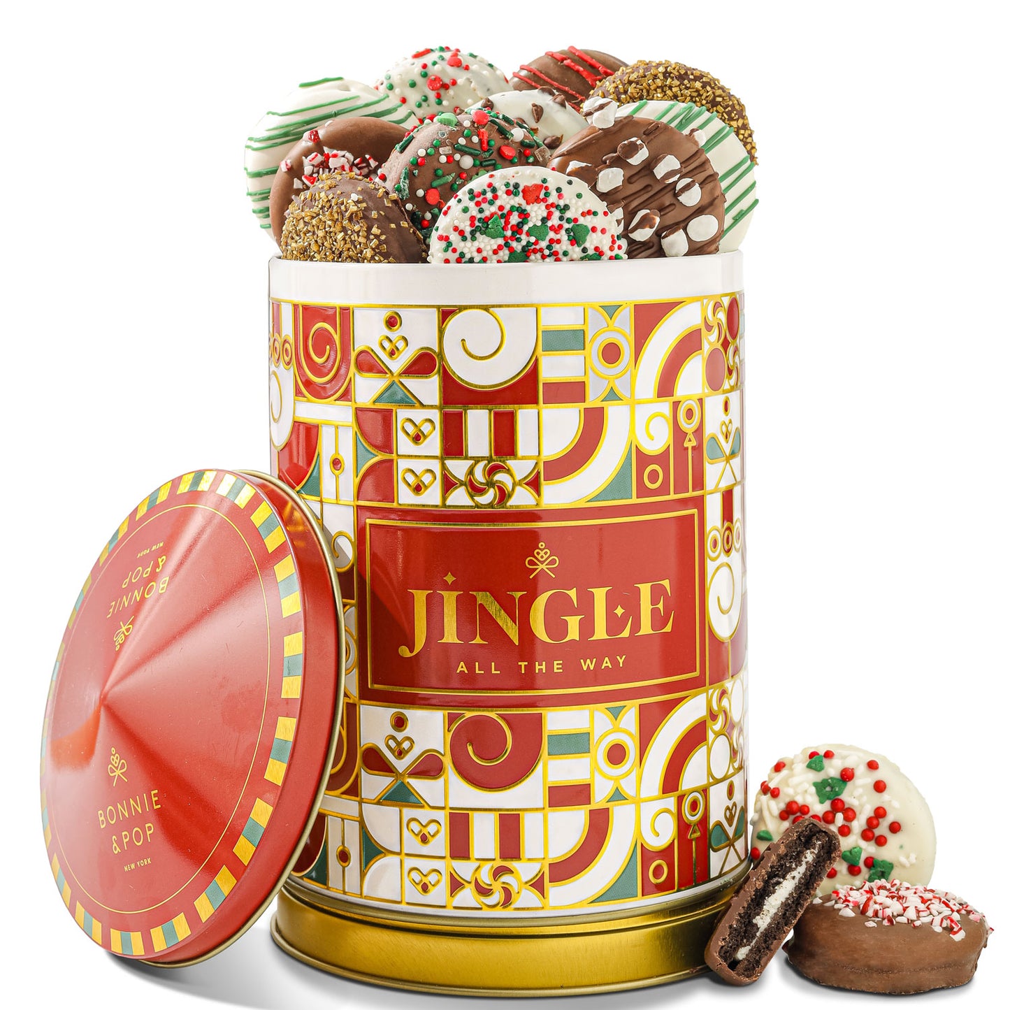 A festive tin with 'JINGLE ALL THE WAY' text, adorned with multicolored accents, filled with milk and white chocolate covered Oreos with holiday toppings.